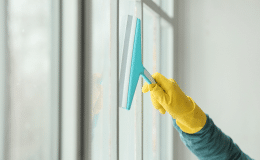 79747481-young-man-cleaning-window-home-1.png